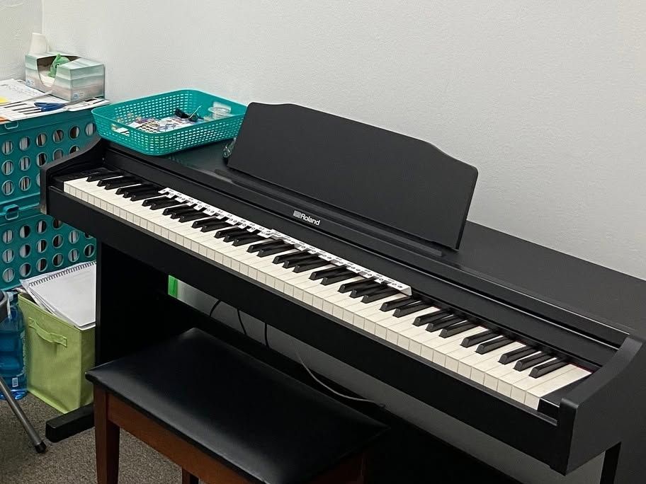 Roland digital piano and bench set up in one of the lesson rooms