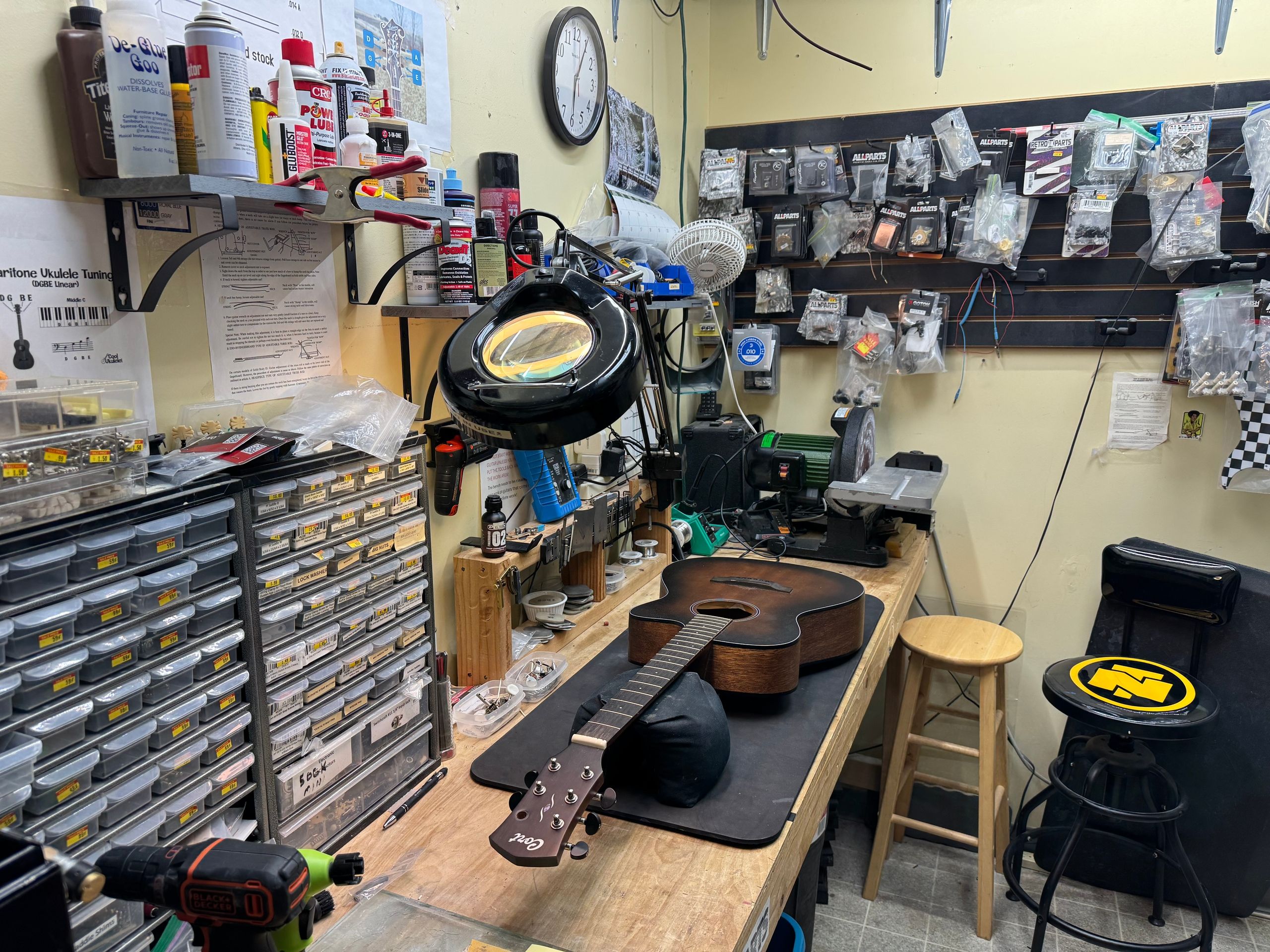 Repair bench wall of parts drawers, glues, clamps, and hand tools
