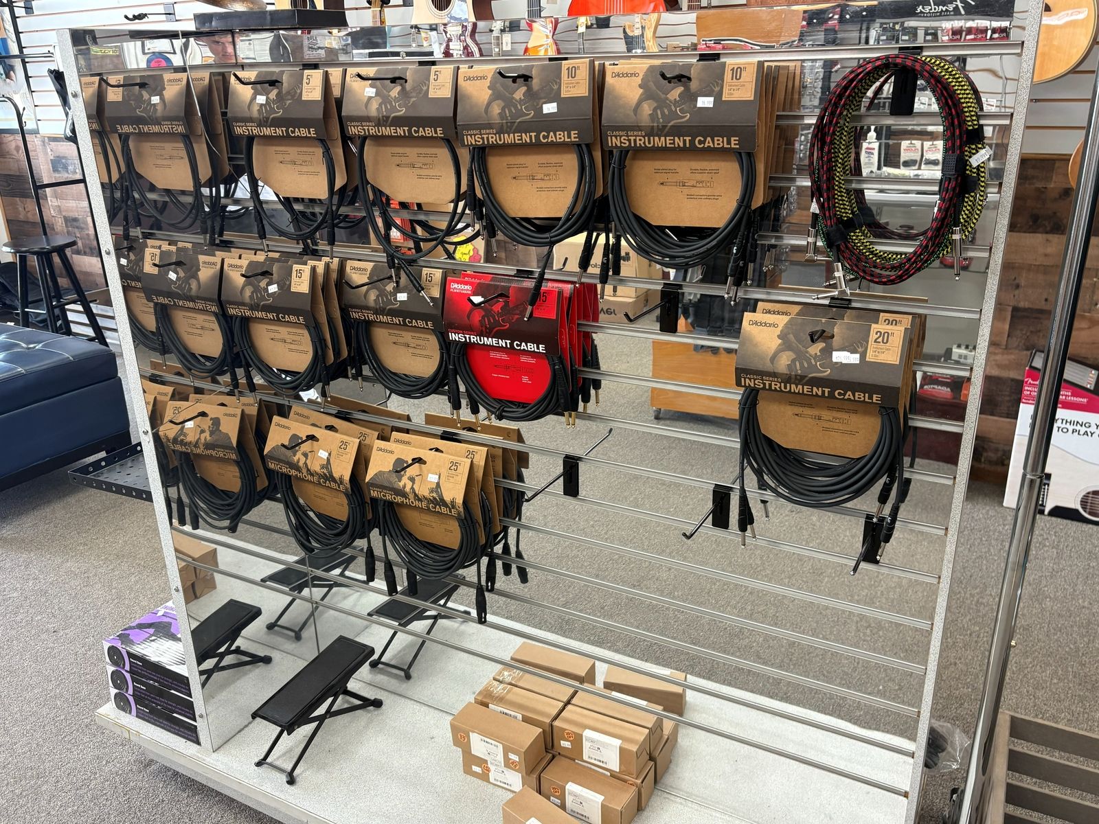 Instrument cables and leads hanging in rows above the folding footstools