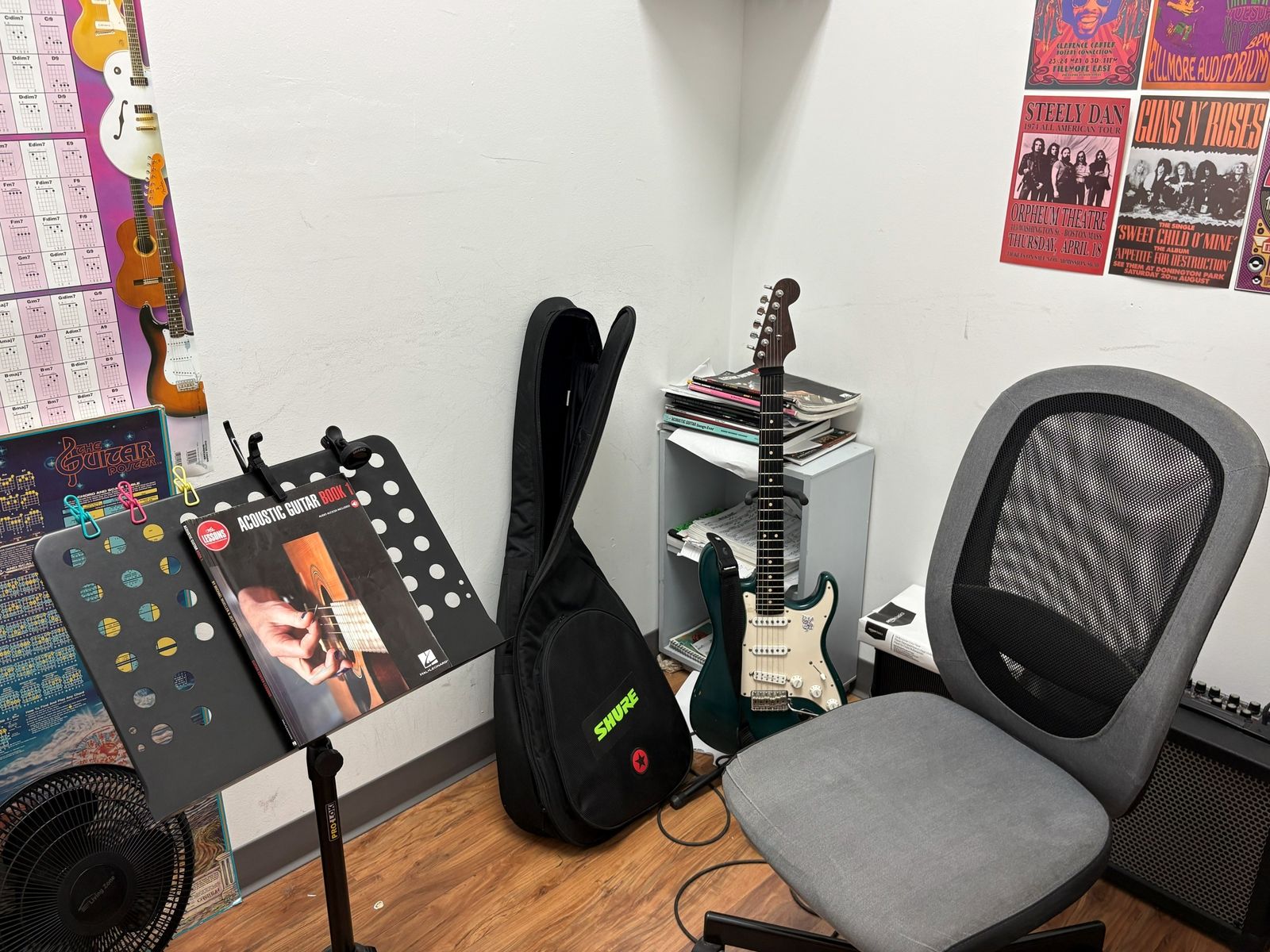 Lesson room with a Stratocaster on its stand, gig bag and music stand ready