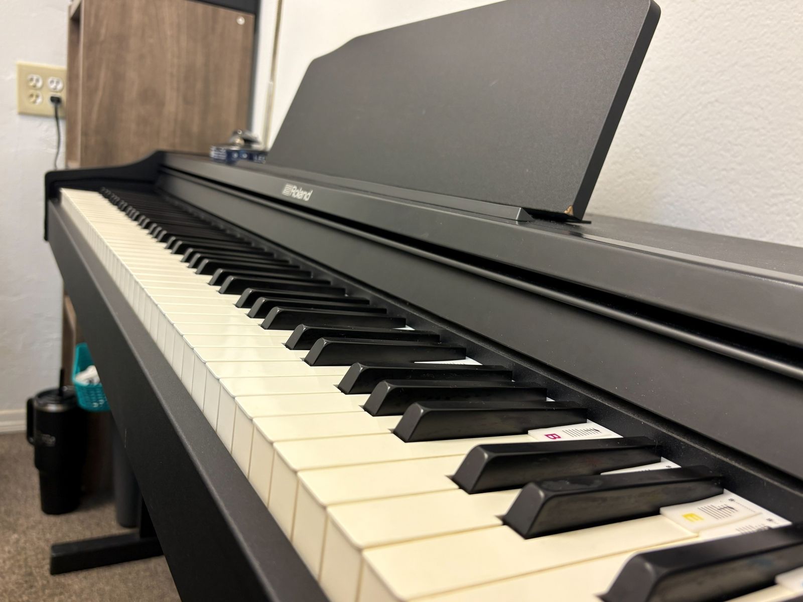 Close view along the keys of the Roland digital piano in the lesson room