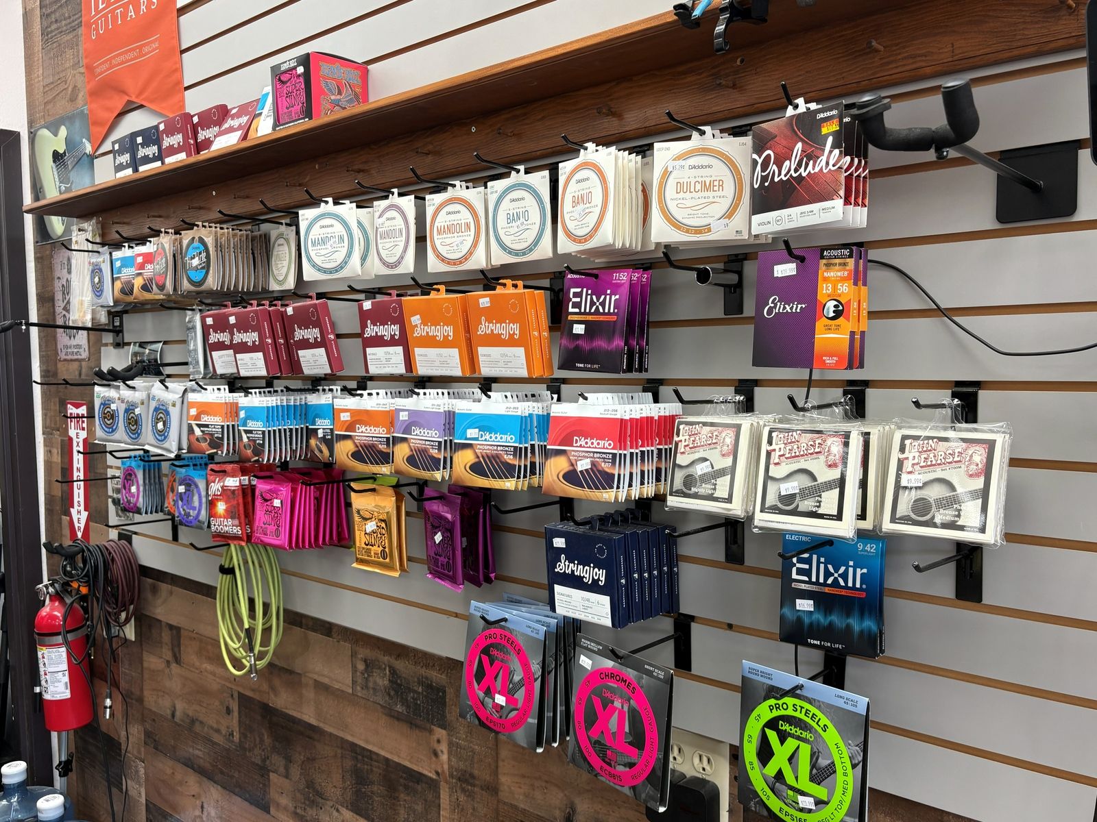 The string wall: Elixir, D Addario, Ernie Ball and Stringjoy sets on pegs